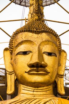 Golden Buddha statue at buddhist temple in Bangkok.