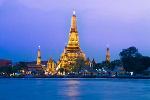 Wat Arun, The Temple of Dawn, at twilight, view across  Chao Phraya river. Bangkok, Thailand.