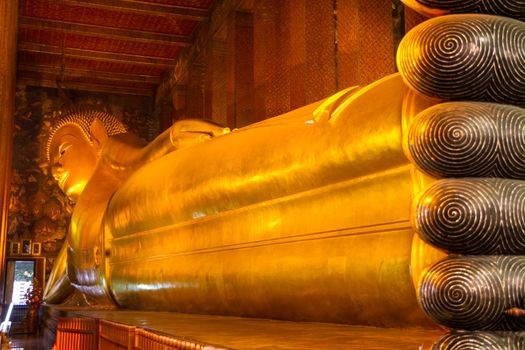 Reclining golden buddha in wat Pho temple, Bangkok, Thailand.
