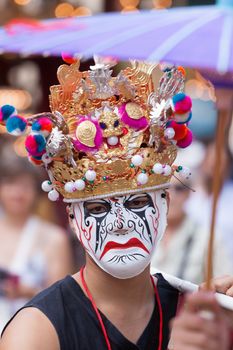 Actor wearing a traditional Japanese mask.