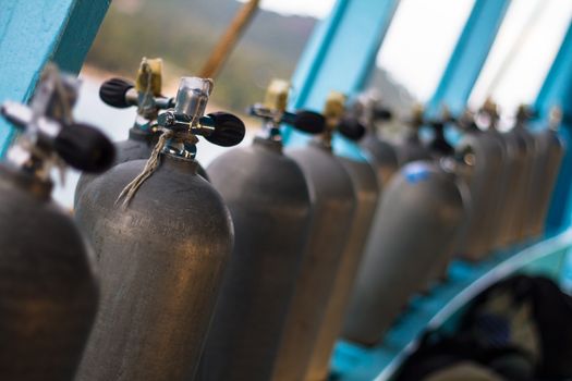 Row of oxigen tanks for scuba diving.