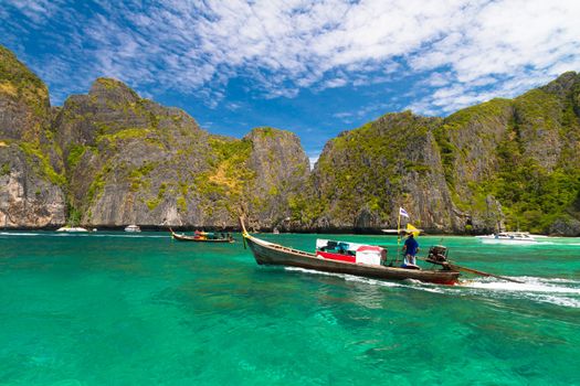 Traditional wooden  boats in a picture perfect tropical bay on Koh Phi Phi Island, Thailand, Asia.
