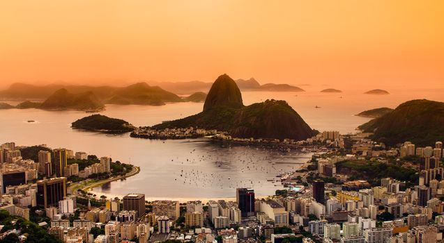 Rio de Janeiro, Brazil. Suggar Loaf and  Botafogo beach viewed from Corcovado at sunset.