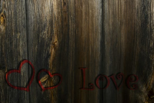 Two red hearts and the inscription on the wooden background, a Valentines theme.