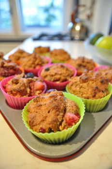 Cooking muffins in colourful plastic cups