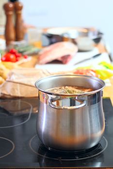 Stell saucepan with soup at the kitchen