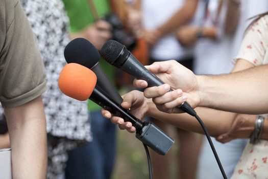 A journalist is making a interview with a microphone