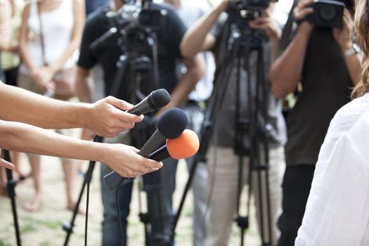 A journalist is making a interview with a microphone