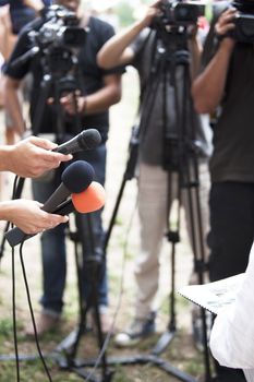 A journalist is making a interview with a microphone