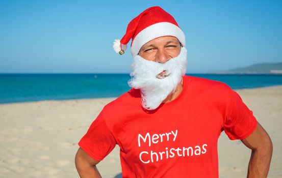 Portrait of young men in Santa hat on tropical vacation