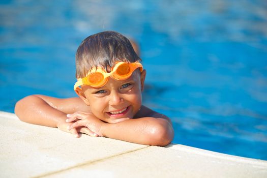 Activities on the pool. Cute boy in swimming pool