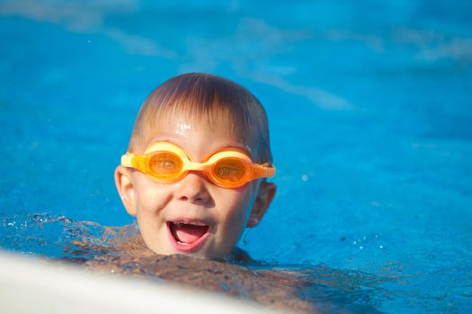 Activities on the pool. Cute boy in swimming pool