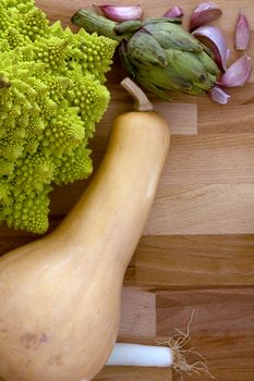 Vegetables on a wooden background with space for text.