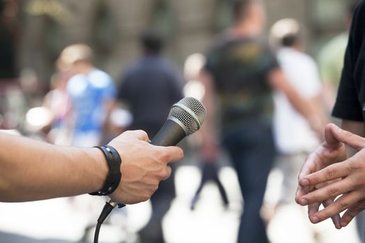 Interview with media microphone held in front of businessman, spokesman or politician