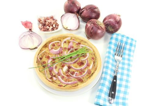 delicious Onion tart with leeks and bacon on a light background