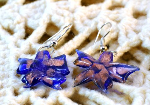 handmade glass flower earrings on the knitted background