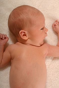 newborn infant on white blanket