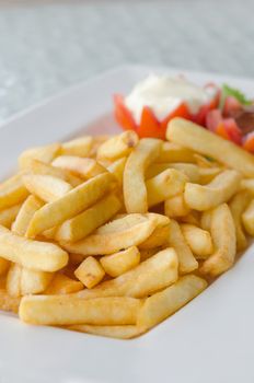 close up a pile of appetizing french fries on white plate