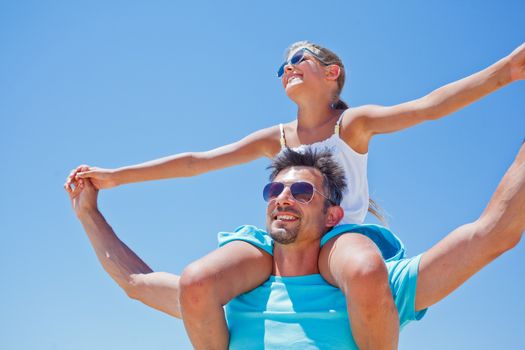 Portrait of father and daughter having fun on tropical beach