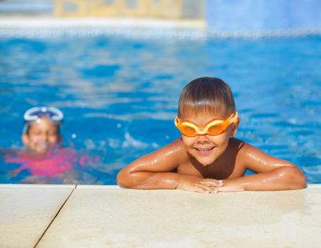 Activities on the pool. Cute boy in swimming pool