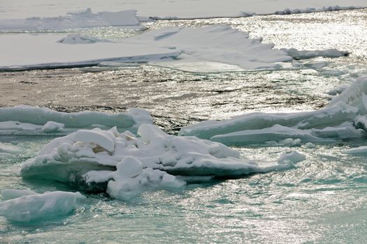 Nature background abstract of flowing open river water in winter with jammed ice floes