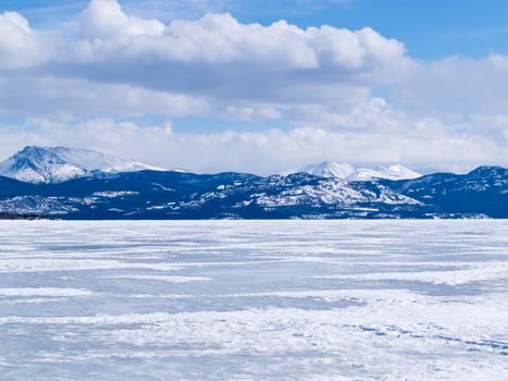 Cold icy winter landscape of frozen Lake Laberge, Yukon Territory, Canada