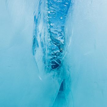 Nature background pattern abstract of underwater crevasse in thick layer of ice floe floating on blue lake water