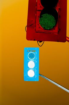 Two traffic lights in wrong negative colors confusing and contradicting against yellow background with copyspace