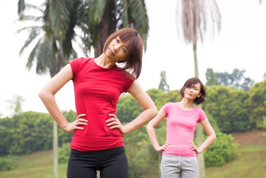 Asian Chinese woman workout outdoor, stretching