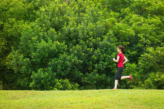 Asian girl jogging at outdoor park
