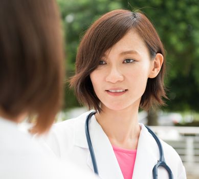 Asian medical people having discussion at hospital corridor. 