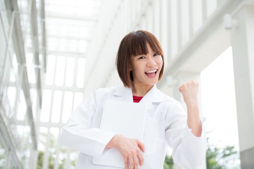 Asian Chinese medical people at the hospital celebrating success.