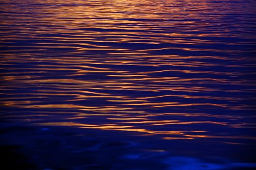 Sunset shining sea, showing beautiful golden and blue ripples