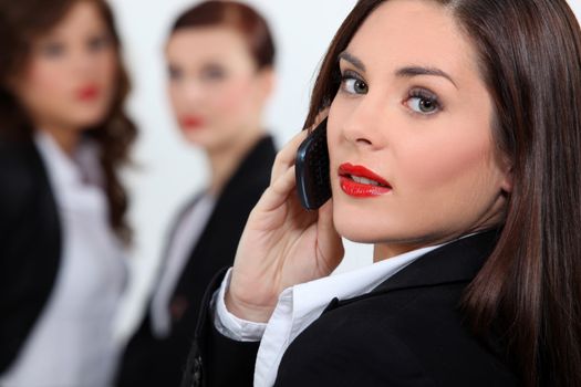 Businesswoman in red lipstick using a cellphone