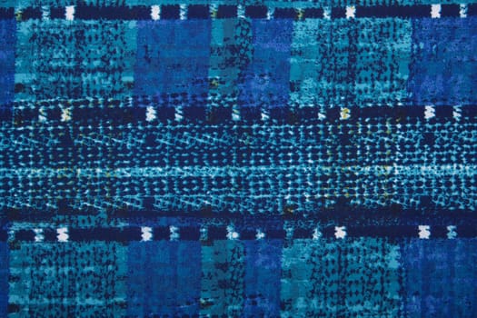 The blue material in an abstract patterns, a textile background.