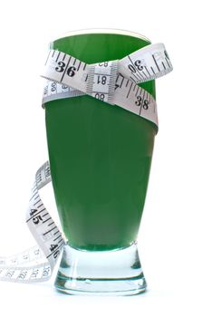 Tape measure around a blended smoothie drink containing healthy green vegetables