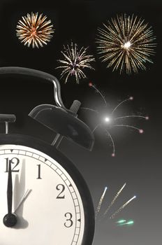 Closeup of a clock face with new years eve fireworks in the background 