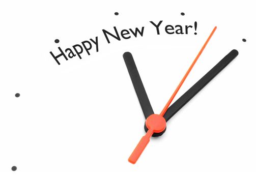 Clock hands pointing towards happy new year 