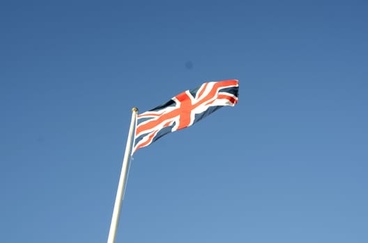 English flag in sunny autumn day against a blue sky