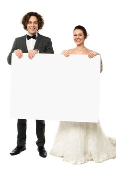 Engaged couple diplaying a blank whiteboard