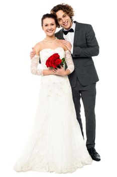 Smiling newlywed couple isolated over white