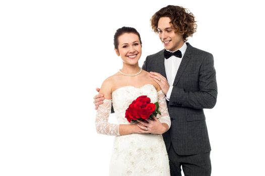 handsome groom standing behind the Pretty bride, love couple