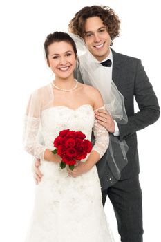 Studio shot of a handsome groom and lovely pretty wife