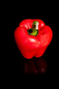 a red sweet pepper on a black background