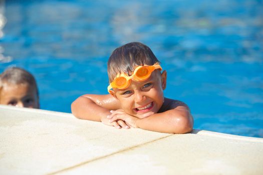 Activities on the pool. Cute boy in swimming pool