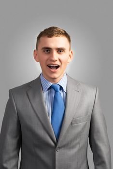 portrait of a young businessman screaming, shouting and looking at the camera
