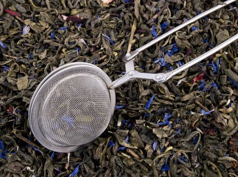 Metal tea infuser and aromatic green tea leaves