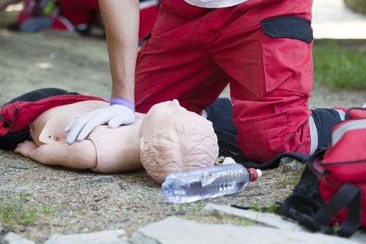 Paramedic demonstrates CPR on dummy