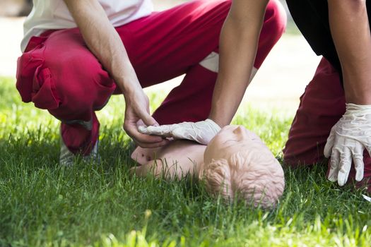 Paramedic demonstrates CPR on dummy