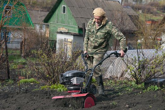 The man cultivates the ground on the site